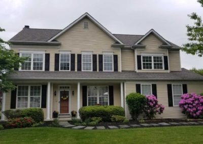 A large house with flowers in front of it.