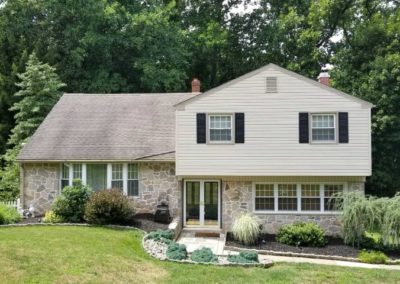 A house with a lot of windows and a porch