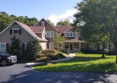 A large house with many trees and bushes