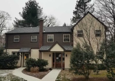 A large house with two floors and a lot of windows.