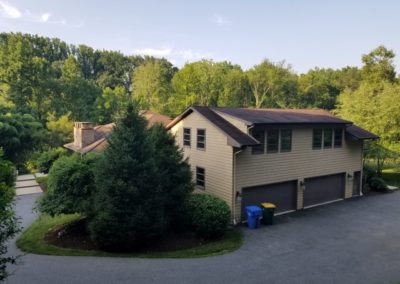 A large house with trees in the background